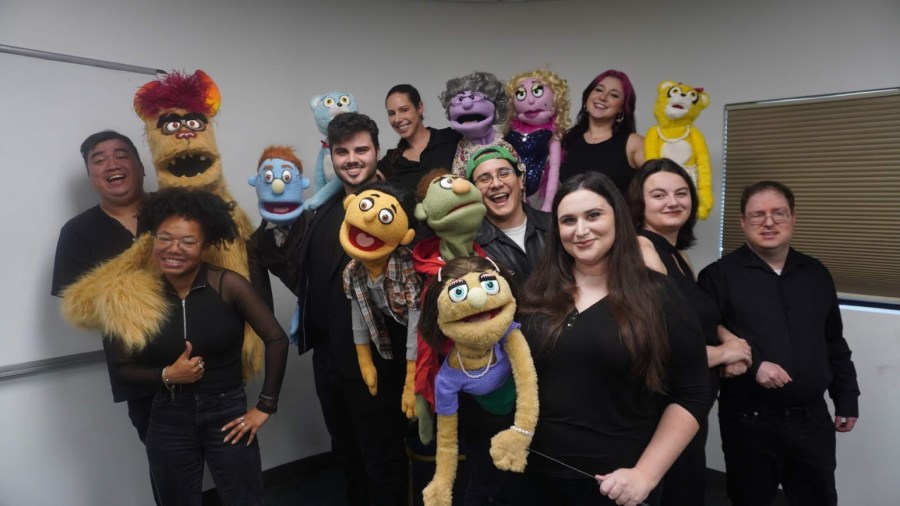 The Avenue Q cast with their puppets.